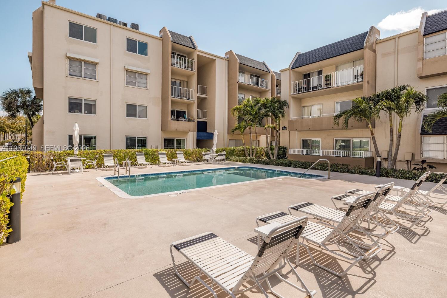 7785 Southwest 86th Street, Unit E119 Miami, FL 33143 - Photo 20 of 33 a view of a building with backyard and trees