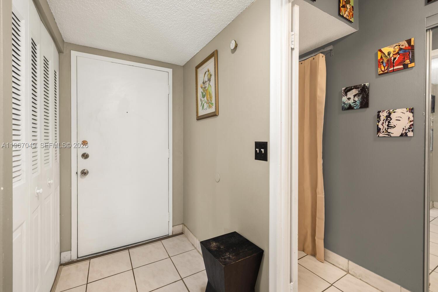 7785 Southwest 86th Street, Unit E119 Miami, FL 33143 - Photo 2 of 33 a view of an entryway with wooden floor