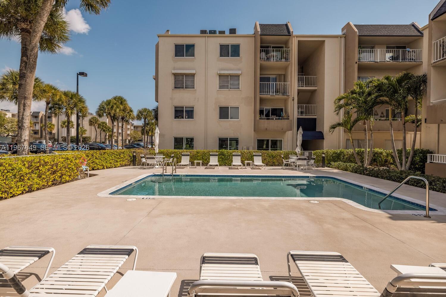 7785 Southwest 86th Street, Unit E119 Miami, FL 33143 - Photo 21 of 33 a view of a tall building from a patio