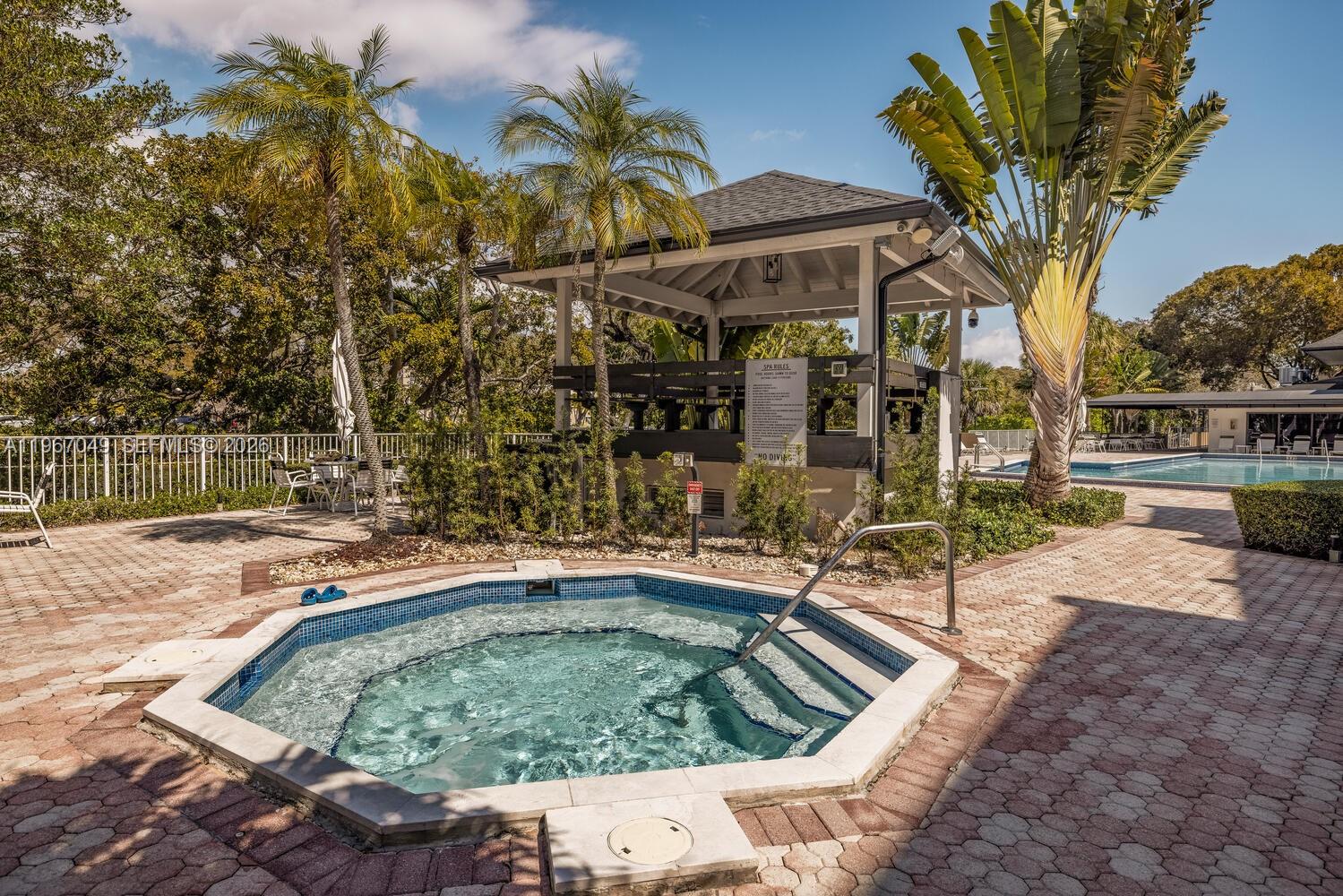 7785 Southwest 86th Street, Unit E119 Miami, FL 33143 - Photo 26 of 33 a view of a swimming pool with a patio
