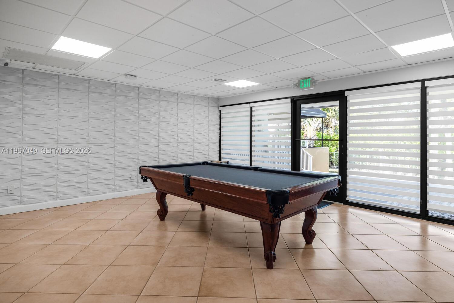 7785 Southwest 86th Street, Unit E119 Miami, FL 33143 - Photo 30 of 33 a room with pool table