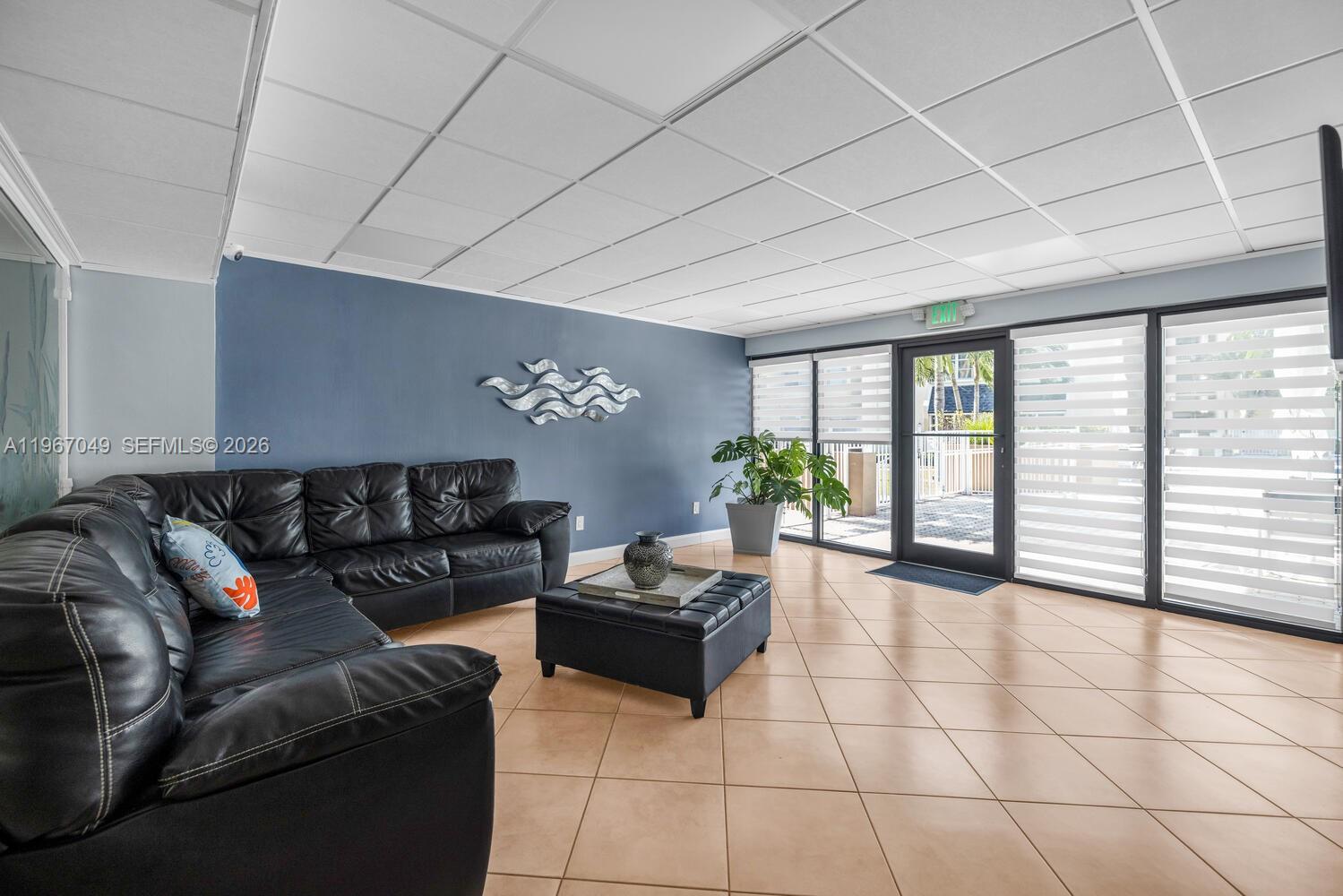 7785 Southwest 86th Street, Unit E119 Miami, FL 33143 - Photo 32 of 33 a living room with furniture and a large window