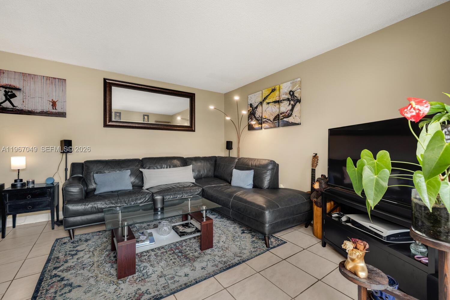 7785 Southwest 86th Street, Unit E119 Miami, FL 33143 - Photo 7 of 33 a living room with furniture and flowers