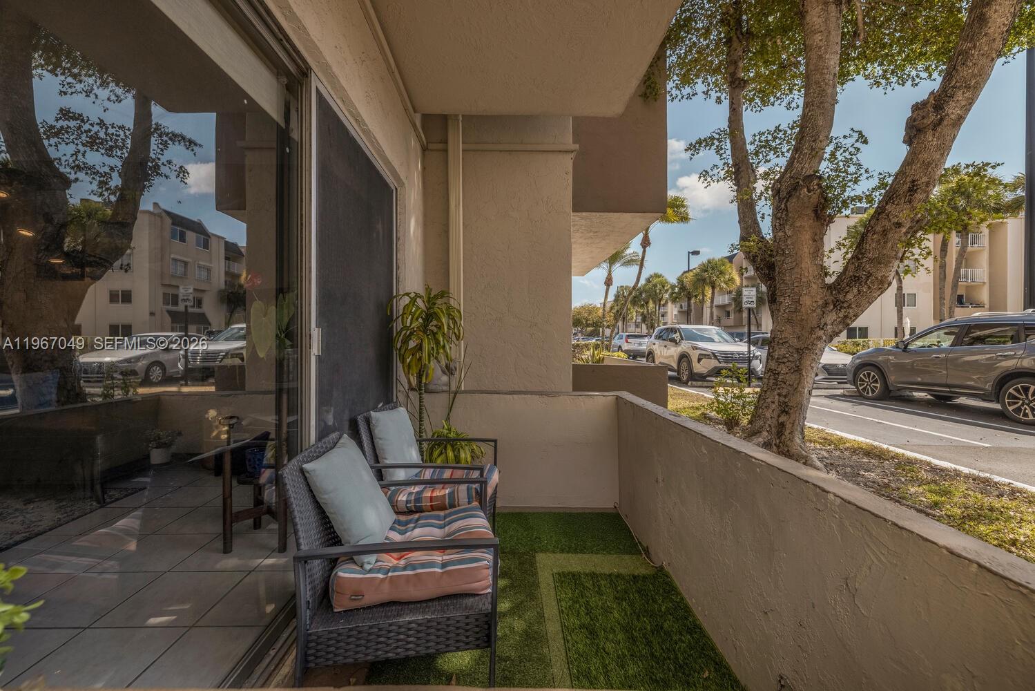 7785 Southwest 86th Street, Unit E119 Miami, FL 33143 - Photo 8 of 33 a view of balcony with chairs
