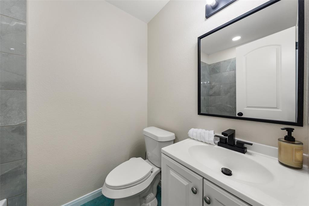 3109 North 27th Street Waco, TX 76708 - Photo 13 of 17 a bathroom with a sink a toilet and mirror