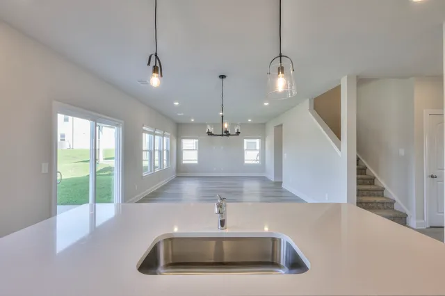 a view of a kitchen with a sink and chandelier