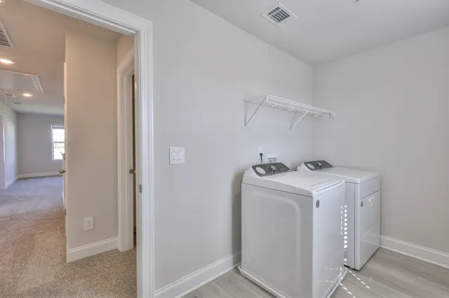 a view of storage and utility room with washer and dryer