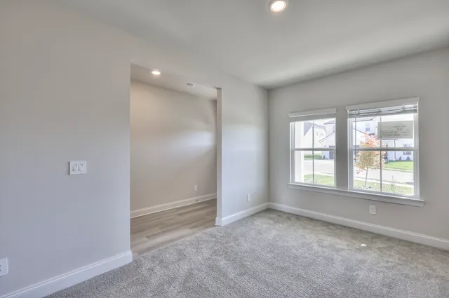 an empty room with windows and closet