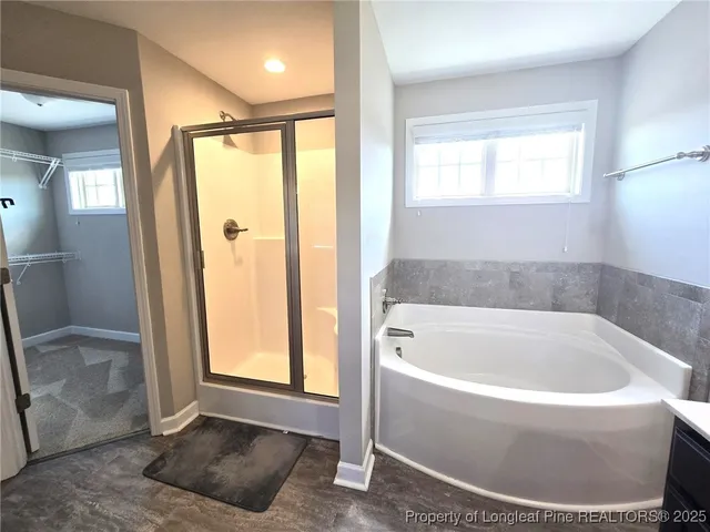 a bathroom with a bathtub and a shower