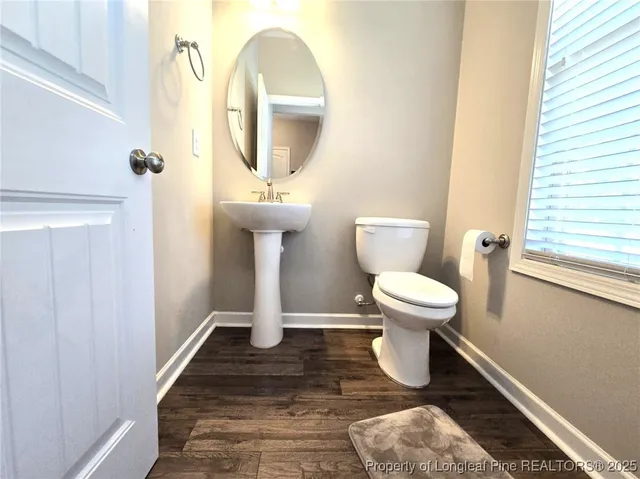 a bathroom with a toilet and a mirror