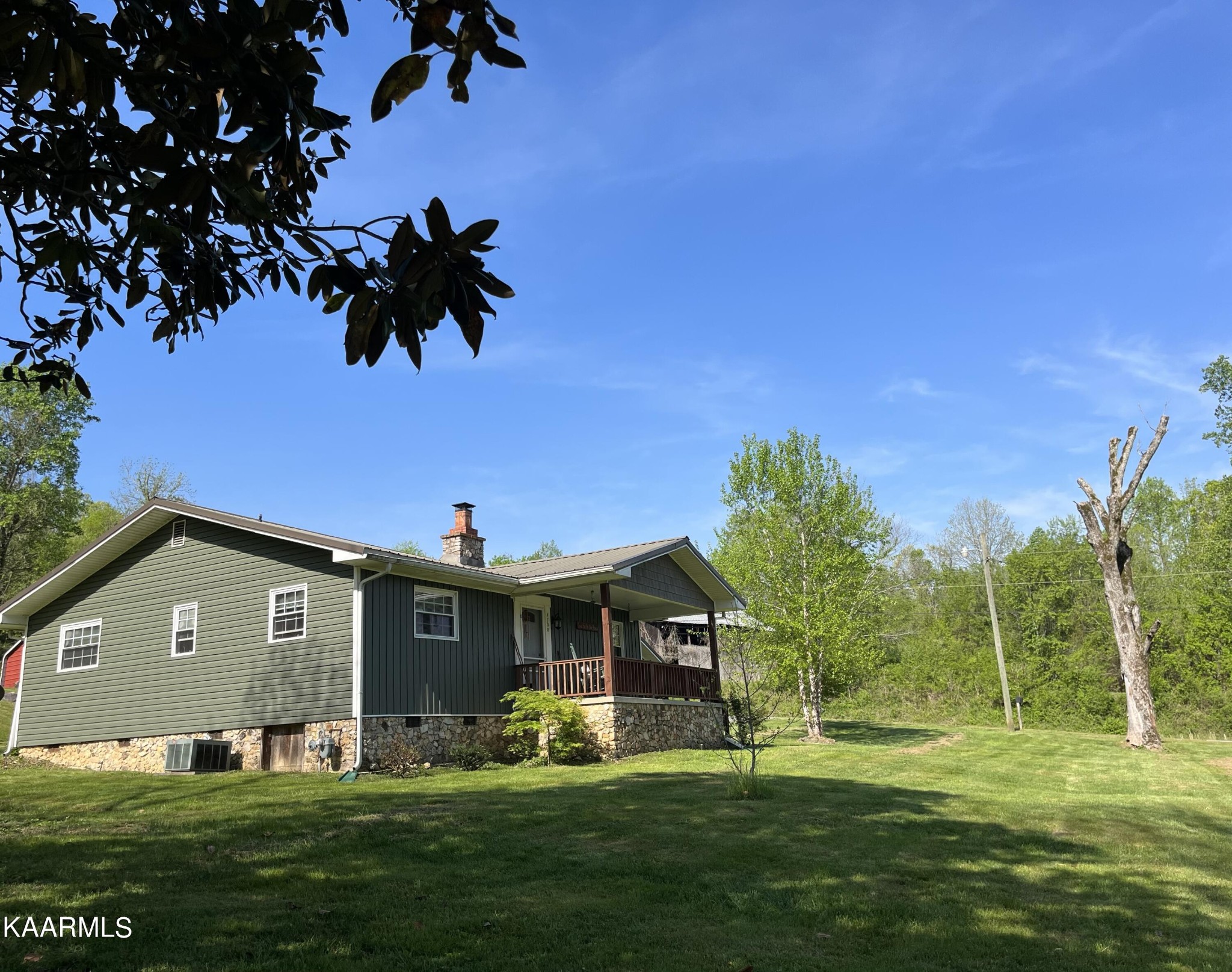 4700 Sunnyside Road Philadelphia, TN 37846 - Photo 1 of 48 a front view of a house with a garden
