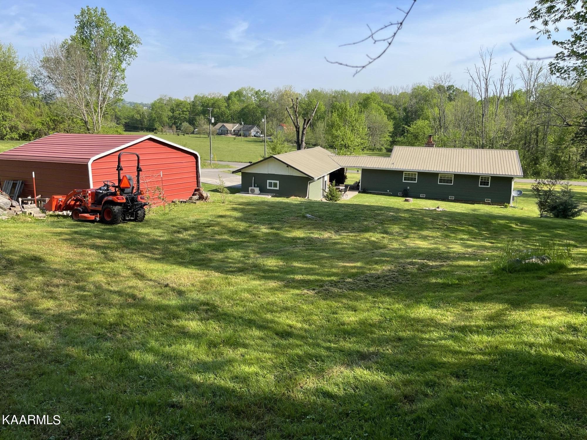 4700 Sunnyside Road Philadelphia, TN 37846 - Photo 19 of 48 a view of a big house with a big yard and large trees