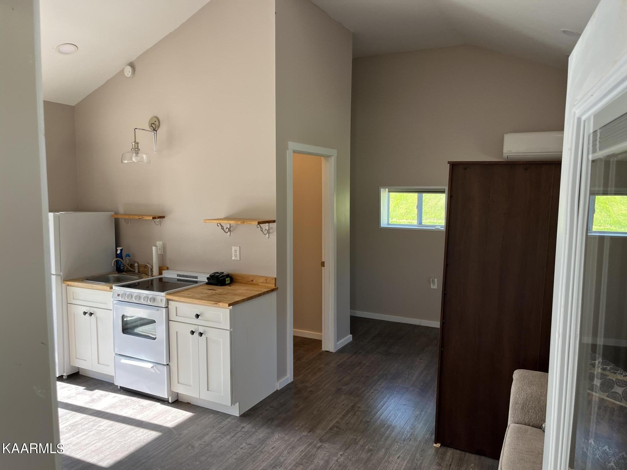 4700 Sunnyside Road Philadelphia, TN 37846 - Photo 29 of 48 a kitchen with a stove and wooden floor