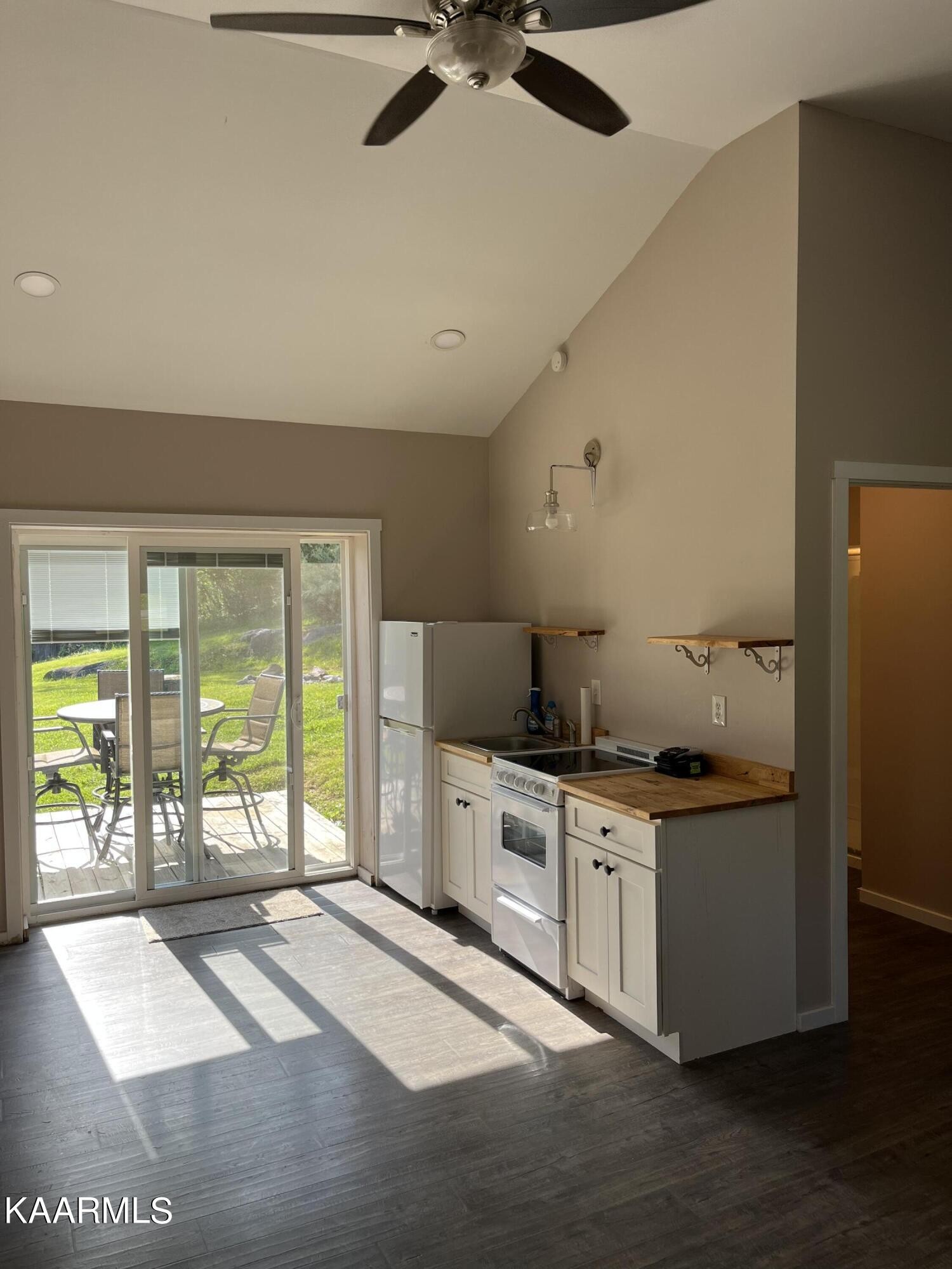 4700 Sunnyside Road Philadelphia, TN 37846 - Photo 32 of 48 a open kitchen with granite countertop a stove top oven a sink and a chandelier
