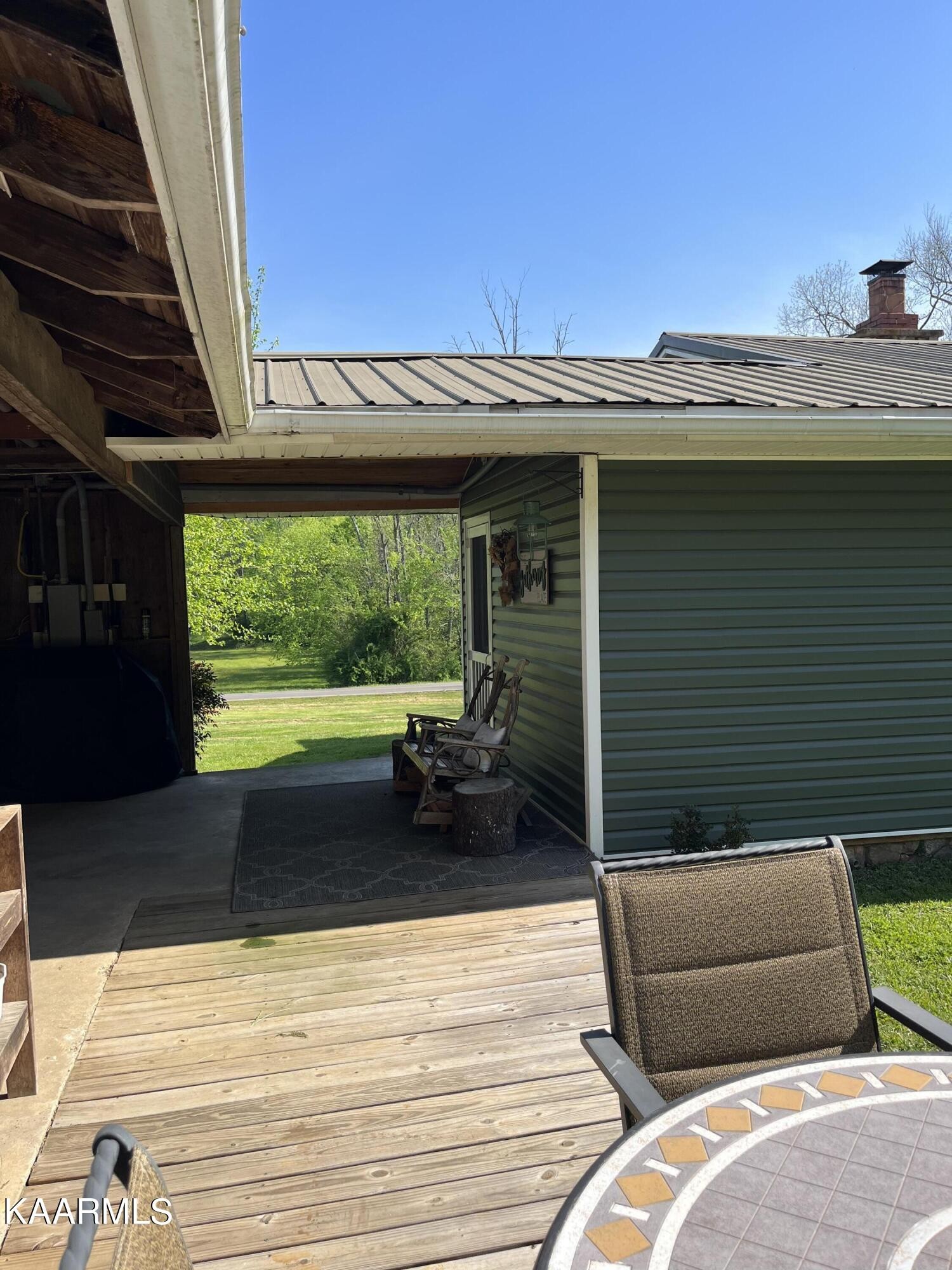 4700 Sunnyside Road Philadelphia, TN 37846 - Photo 41 of 48 a view of a balcony with furniture and a floor to ceiling window