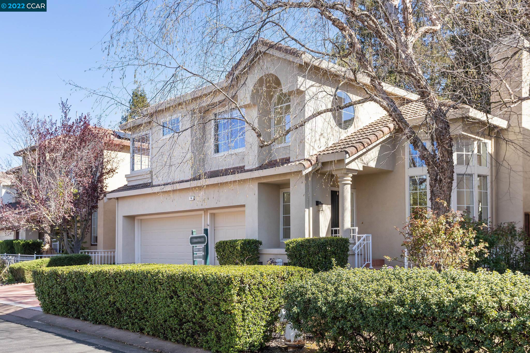 a front view of a house with a garden