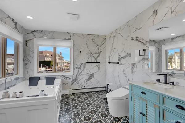 a bathroom with a sink toilet a mirror and shower