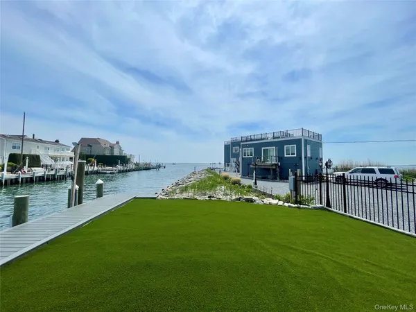a view of roof deck with couches and ocean view