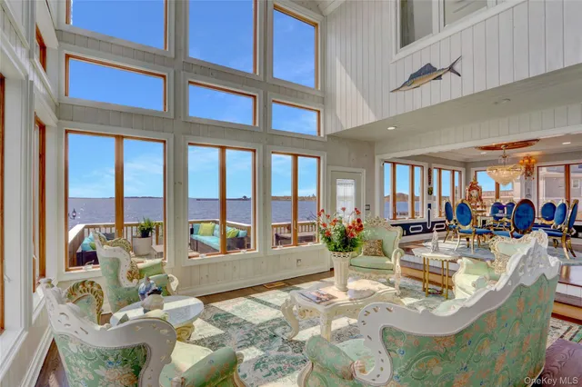a kitchen with a stove a counter space and a view of living room
