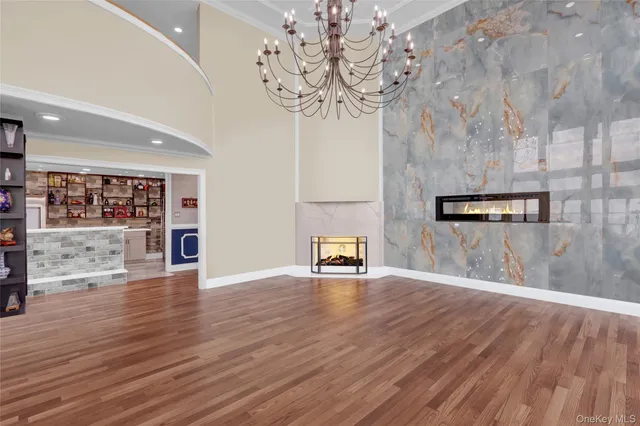 a kitchen with a stove a counter space and a view of living room