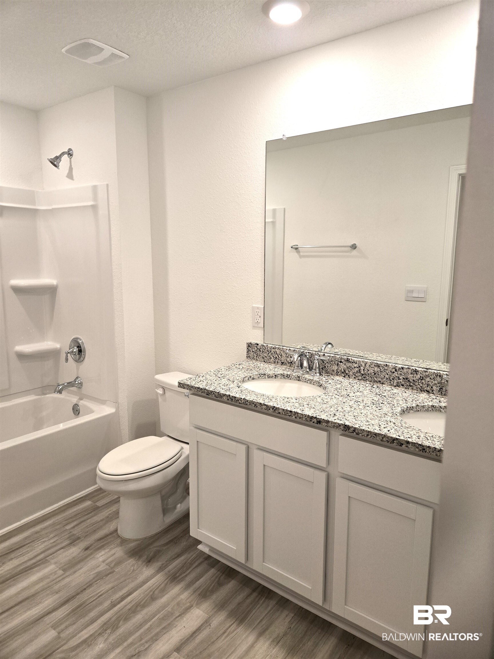 24385 Ringneck Loop Elberta, AL 36530 - Photo 20 of 33 Full bathroom with vanity, a textured ceiling, shower / tub combination, hardwood / wood-style floors, and toilet