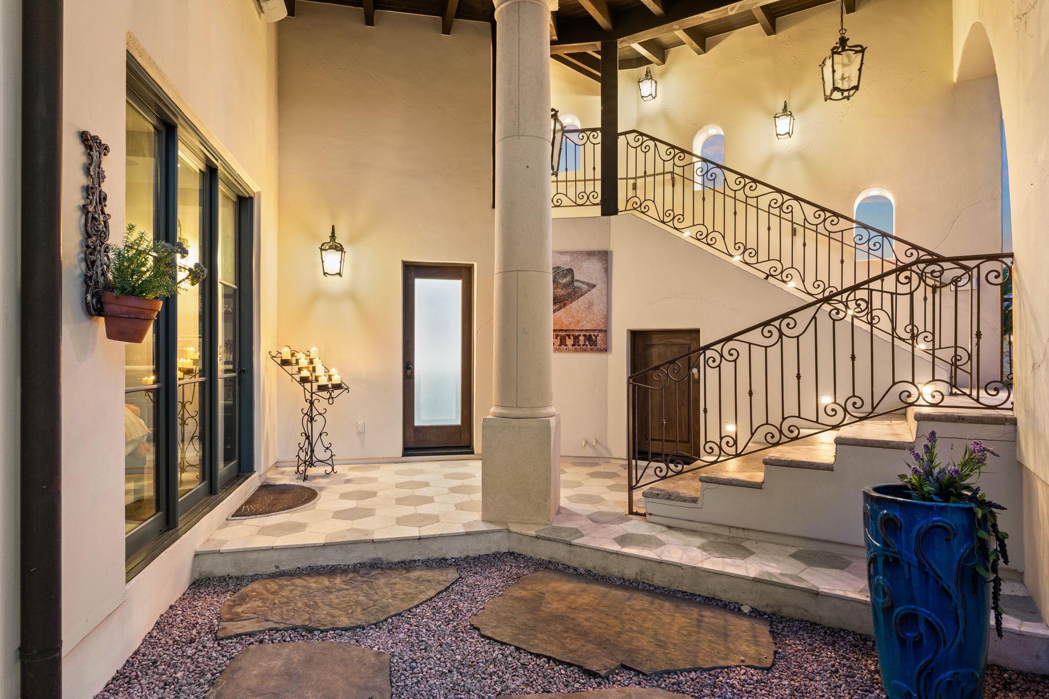11941 Overlook Pass Austin, TX 78738 - Photo 26 of 40 Two-story interior courtyard with a grand staircase featuring ornate wrought iron railings
