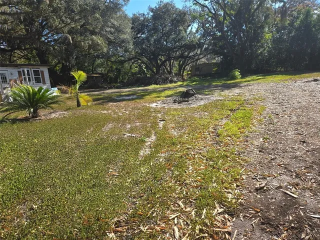 a swimming pool with some trees and wooden fence