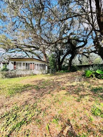 a view of house with yard