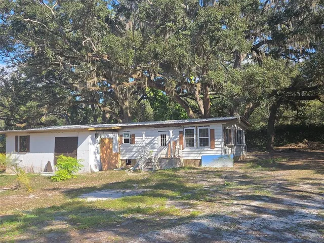 a front view of house with yard patio and swimming pool