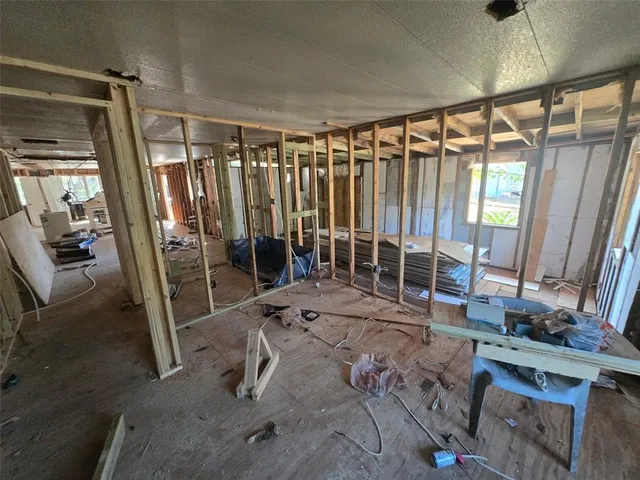 a dining room with wooden floor and furniture