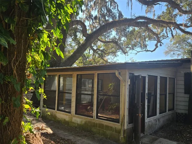 a view of a house with a tree in front of it
