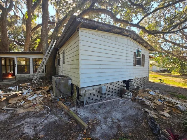 a view of house with backyard space and garden