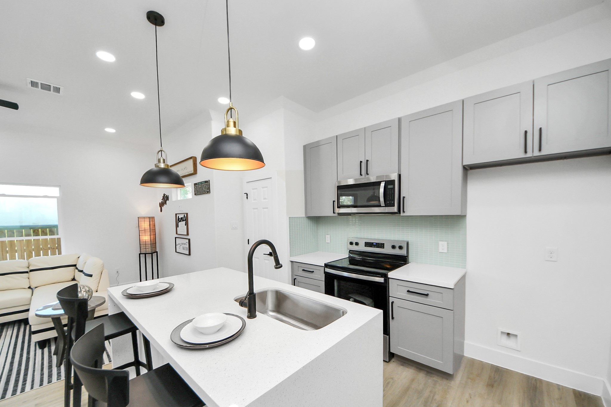 9305 Jutland Road Houston, TX 77033 - Photo 11 of 41 a kitchen with stainless steel appliances granite countertop a stove a sink a refrigerator a dining table and chairs with wooden floor