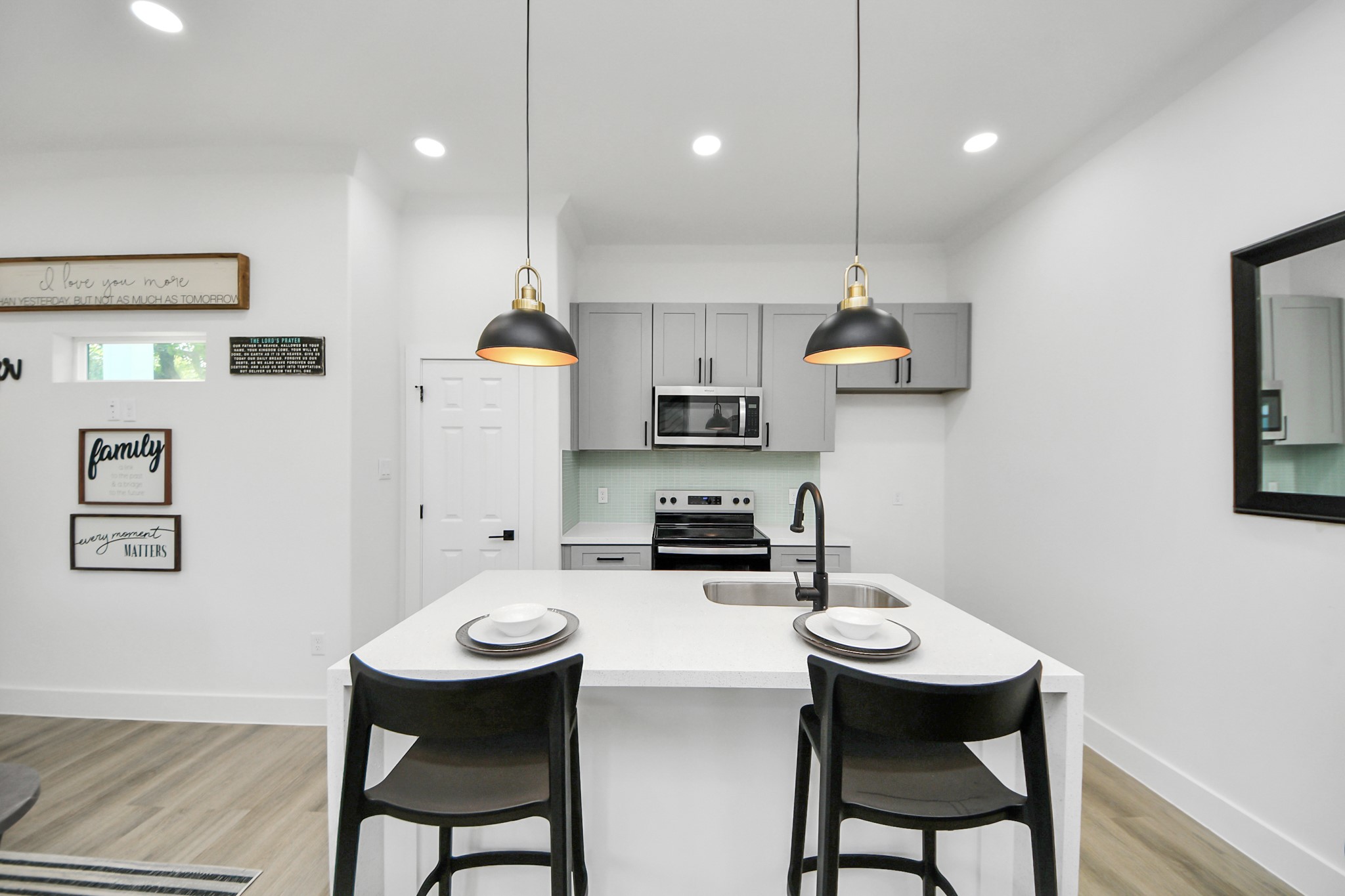 9305 Jutland Road Houston, TX 77033 - Photo 7 of 41 a kitchen with stainless steel appliances kitchen island a table and chairs in it
