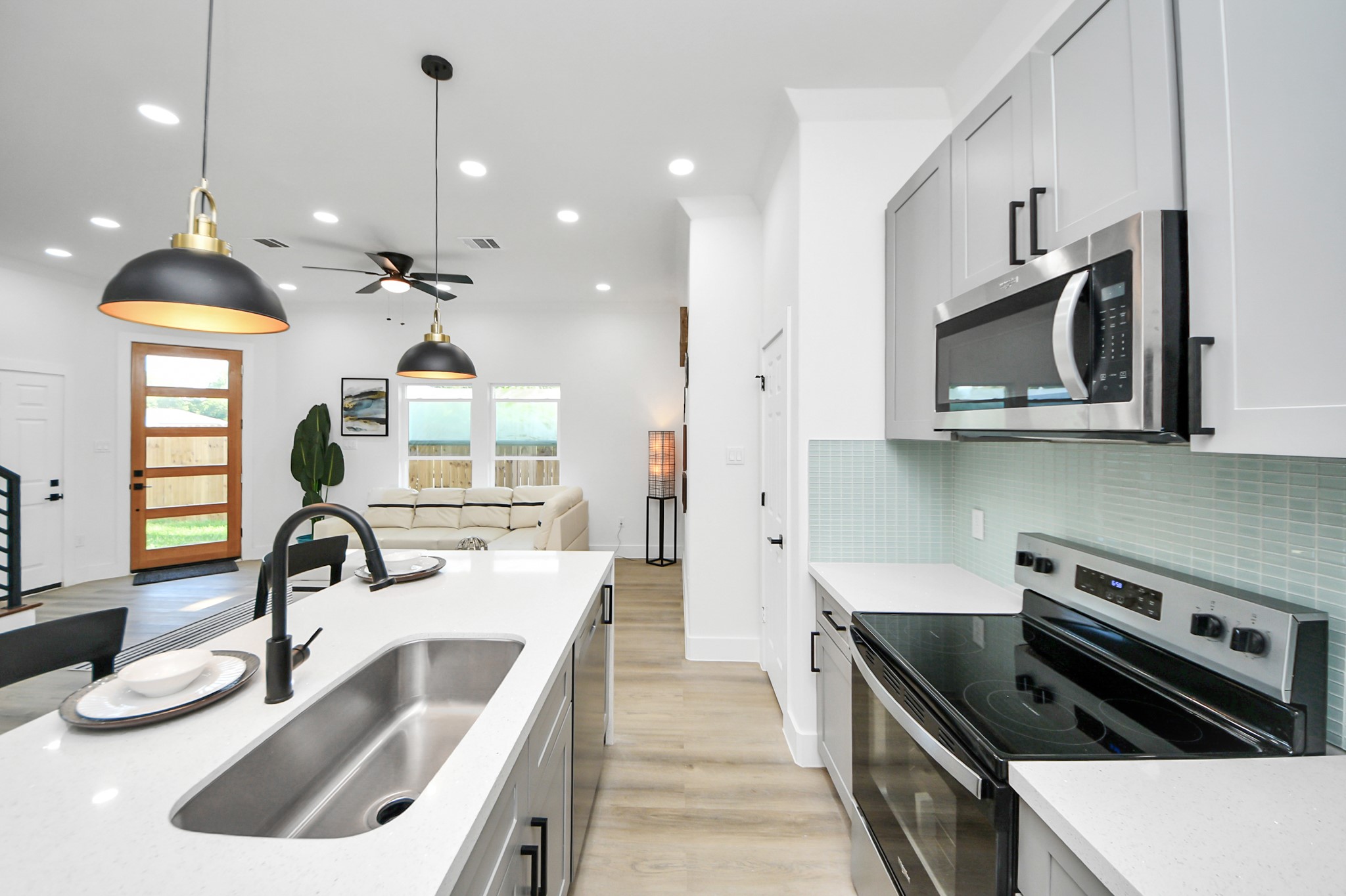 9305 Jutland Road Houston, TX 77033 - Photo 10 of 41 a kitchen with a sink stove and microwave
