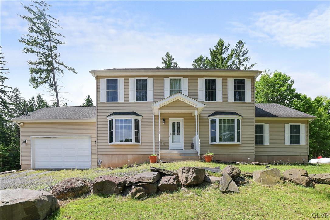 625 Buckle Boot Road Henryville, PA 18332 - Photo 1 of 40 a front view of a house with a yard outdoor seating and garage
