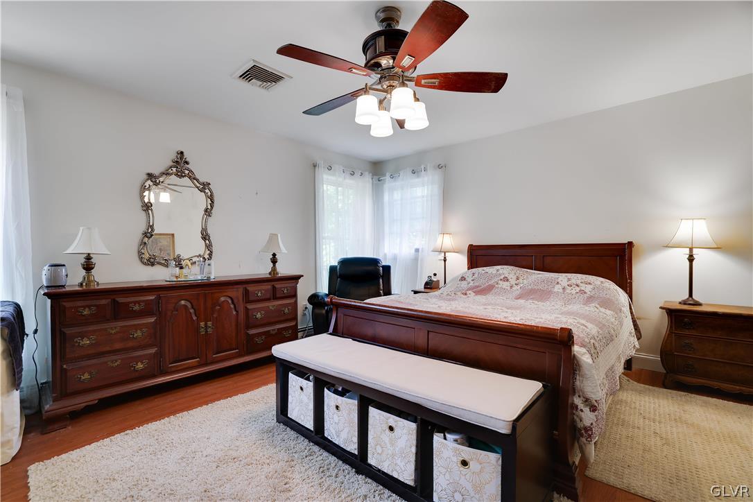 625 Buckle Boot Road Henryville, PA 18332 - Photo 22 of 40 a bedroom with a bed and a chandelier