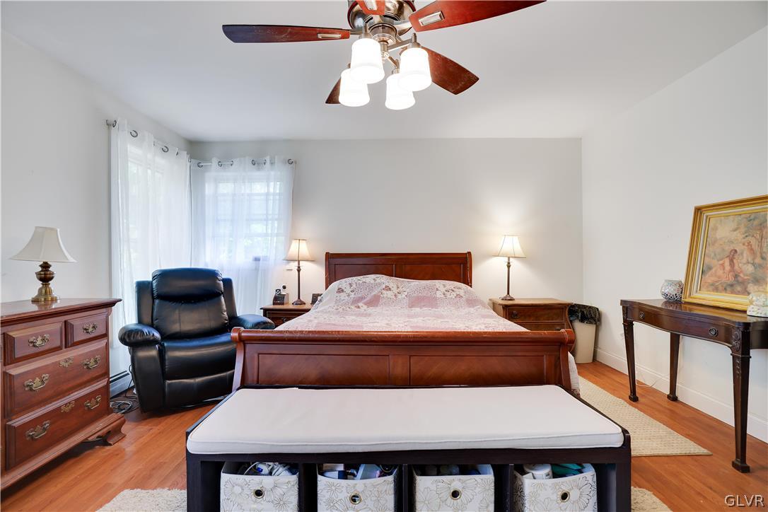 625 Buckle Boot Road Henryville, PA 18332 - Photo 23 of 40 a bedroom with a bed and a chandelier