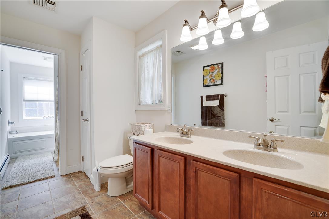 625 Buckle Boot Road Henryville, PA 18332 - Photo 25 of 40 a bathroom with a sink a toilet and a mirror