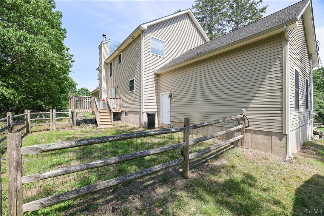 625 Buckle Boot Road Henryville, PA 18332 - Photo 34 of 40 a backyard of a house with wooden fence and large trees