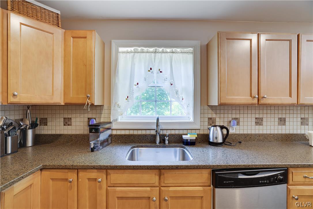 625 Buckle Boot Road Henryville, PA 18332 - Photo 9 of 40 a kitchen with stainless steel appliances granite countertop a sink a counter space and cabinets