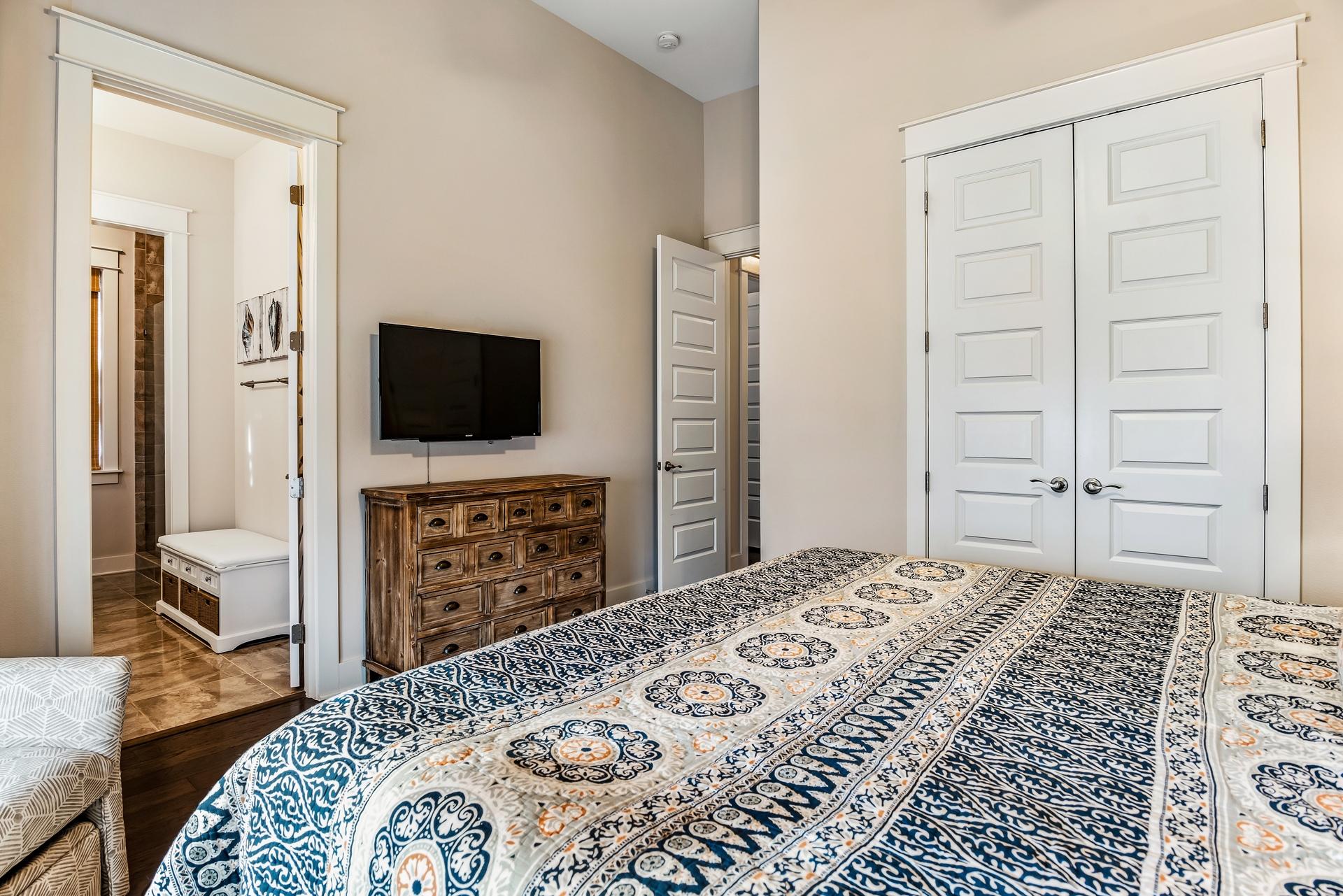 95 York Ln Inlet Beach, Unit B Inlet Beach, FL 32461 - Photo 22 of 28 a bedroom with a bed and a flat screen tv