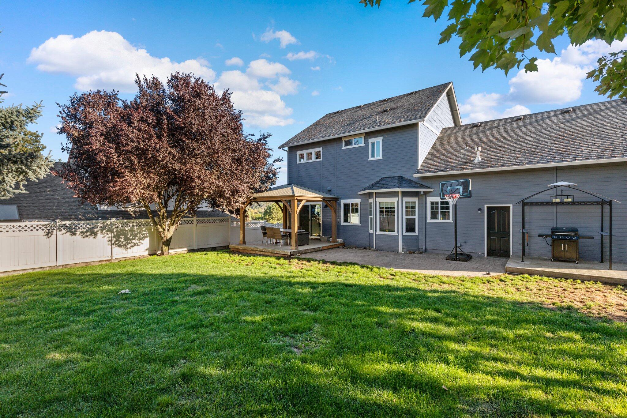 878 Ridgeview Drive Eagle Point, OR 97524 - Photo 30 of 39 a view of a house with a big yard potted plants and large tree