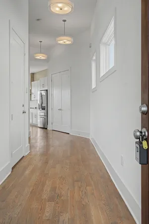 a view of empty room with kitchen and sink