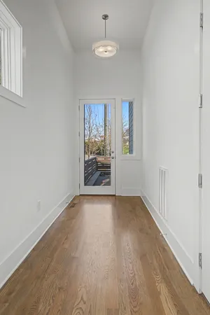 wooden floor in an empty room with a window