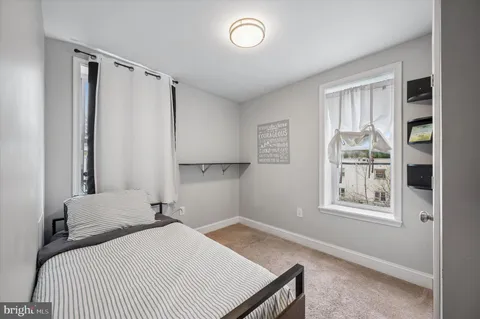 a view of a bedroom with furniture and windows