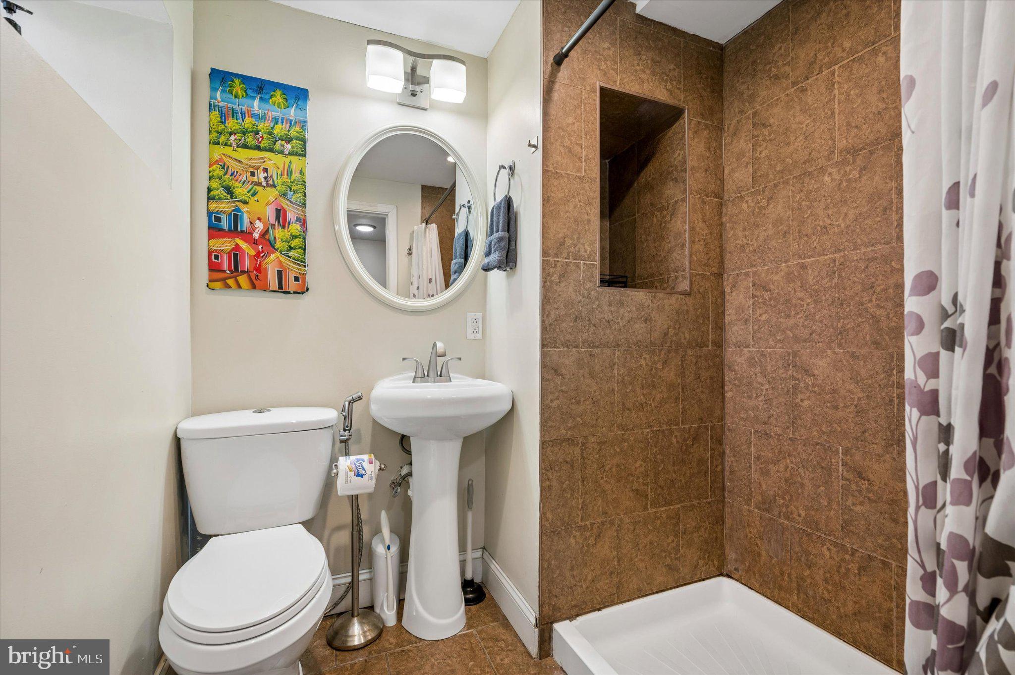 516 High Street Philadelphia, PA 19144 - Photo 25 of 31 Charming bathroom with vibrant art.