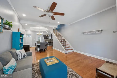 a dining room with furniture entryway and wooden floor