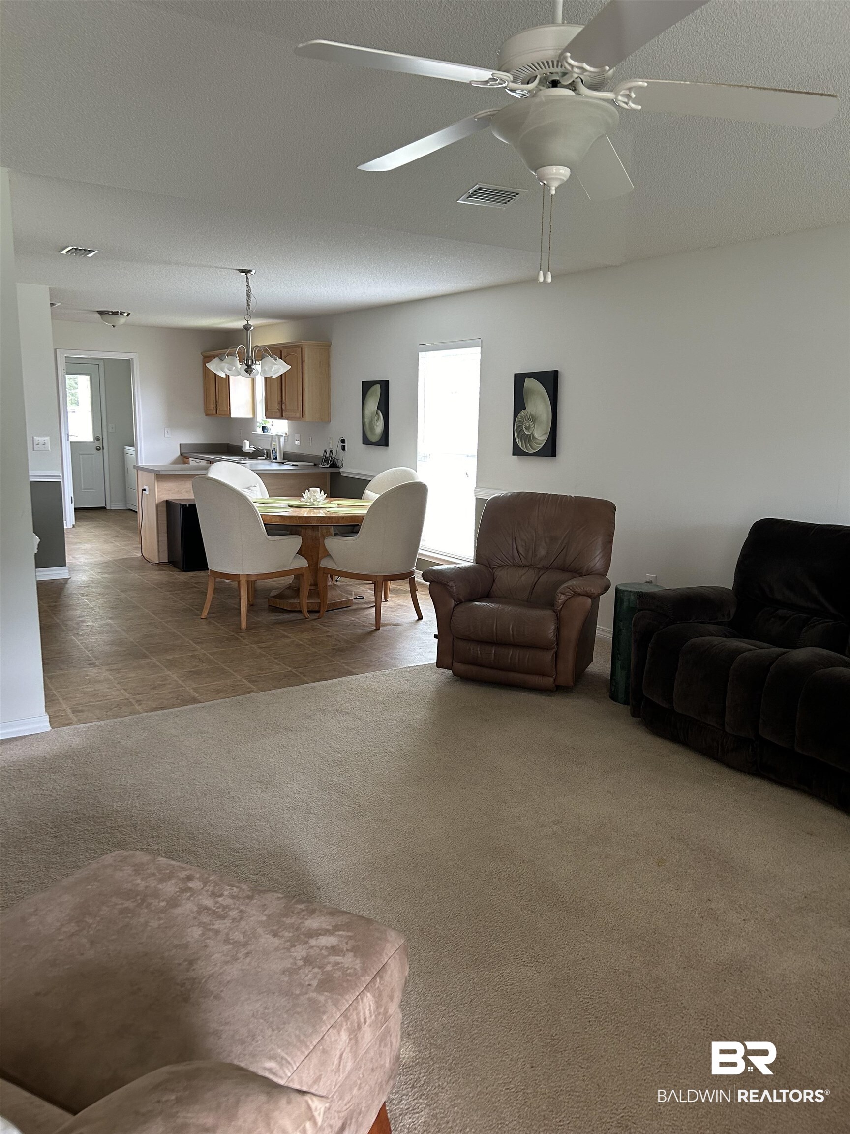 16976 Sugar Loop Foley, AL 36535 - Photo 3 of 16 Carpeted living room with a textured ceiling, a healthy amount of sunlight, and ceiling fan
