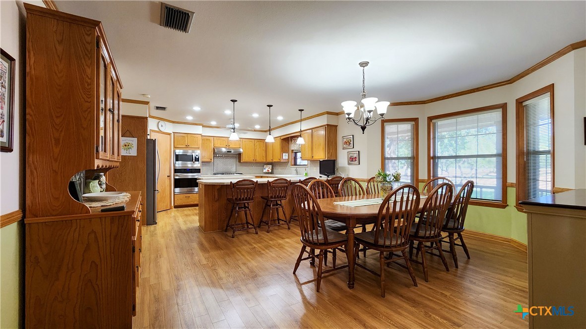 847 Oliver Road Victoria, TX 77904 - Photo 14 of 47 a view of a dining room with furniture window and wooden floor